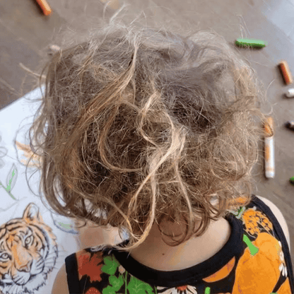 Before and after comparison of a child's hair. Before is dirty and matted, and after is clean and shiny. 