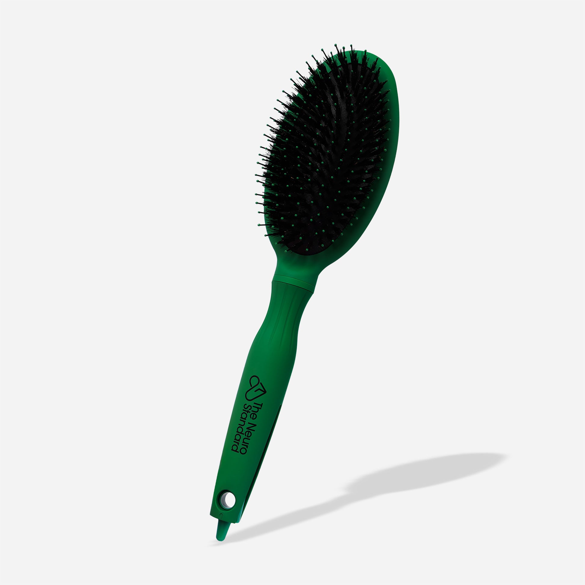 Knot Your Typical Wet/Dry Detangling Hairbrush by The Neuro Standard. Soothing green color with specialized soft bristles and a built-in parting tip for sensory-sensitive hair care.