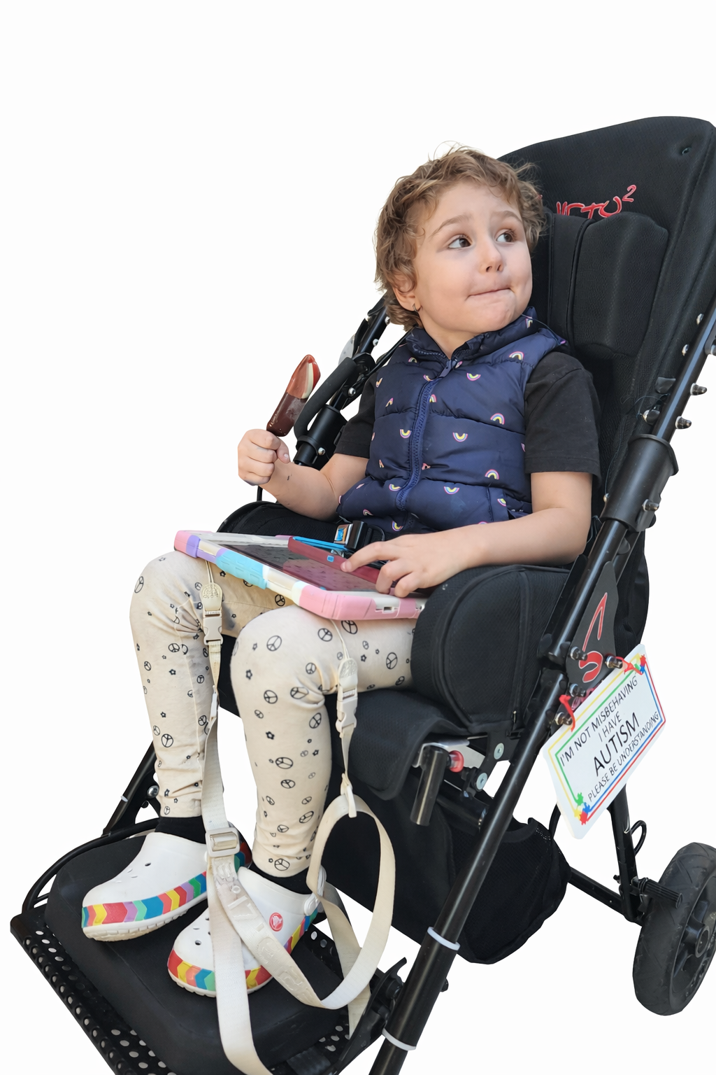 Young girl named Maya, who is autistic, sitting in her specialized stroller holding a snack and a tablet. The accompanying 'Our Story' text describes the traumatic experience of brushing her hair and the moment of frustration that led to the creation of The Neuro Standard.